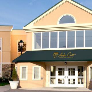 Entrance of a commercial building with a green awning and large windows.