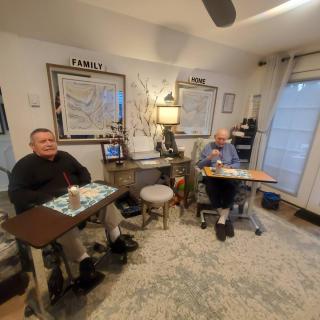 Two people seated in a cozy office setting.