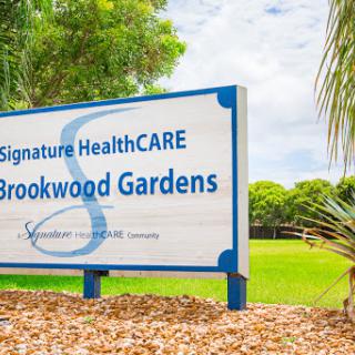 Entrance sign of Signature HealthCARE located at Brookwood Gardens.