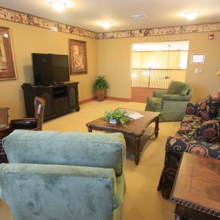A cozy living room with comfortable seating and a TV setup.