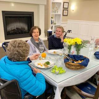 Seniors enjoying a communal meal together in a cozy dining environment.