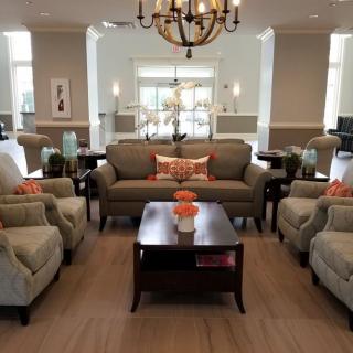 A well-decorated living room with comfortable seating and elegant lighting.