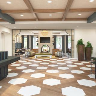 A modern lobby with geometric patterned flooring, comfortable seating, and stylish decor.