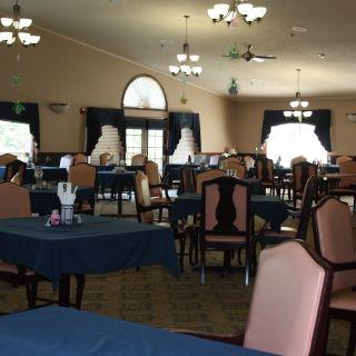 An elegant dining room with neatly arranged tables and chairs.