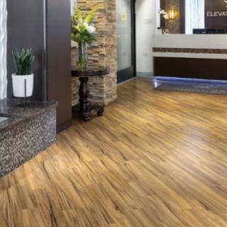 A modern lobby featuring sleek wood flooring and a stylish reception desk.