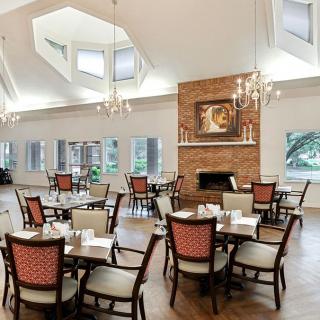 A spacious, elegant dining area with sophisticated lighting and a cozy fireplace.