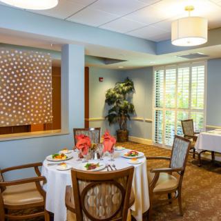 A cozy dining area featuring elegantly set tables and a welcoming atmosphere.