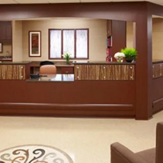 A neat and professional reception area with a desk and seating.