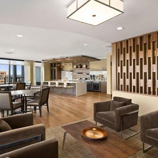 A spacious modern open-plan living and dining area with a sleek kitchen.