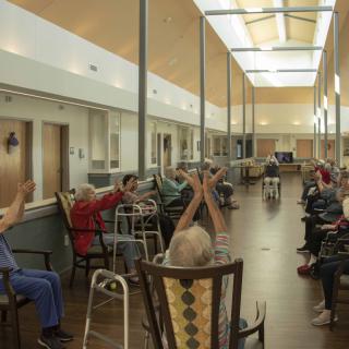 Elderly residents engaged in a group activity at a nursing home.