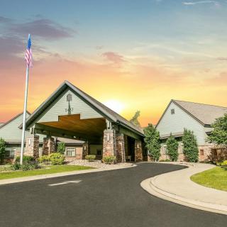 A beautiful church building with a flagpole at sunset.