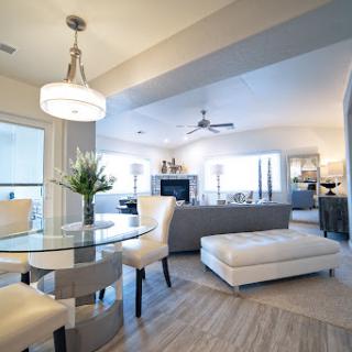 A stylish and modern open-concept living and dining area, featuring contemporary furniture and ample natural light.
