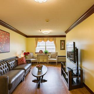 A cozy living room with stylish furniture and a television.