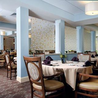 An elegant restaurant interior with neatly arranged tables and chairs.