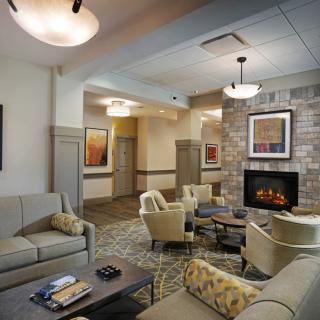 A cozy living room with comfortable seating and a fireplace.