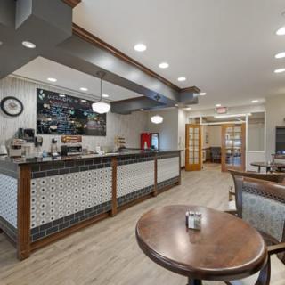 Cozy cafe interior with a modern coffee counter and seating area.
