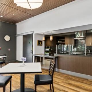 A modern restaurant dining area with contemporary furniture and wood flooring.
