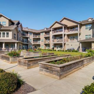 A modern apartment complex with landscaped gardens and balconies.