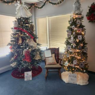 A cozy holiday setting featuring two beautifully decorated Christmas trees.