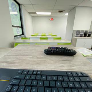 A modern office space featuring multiple desks and a keyboard with a mouse.