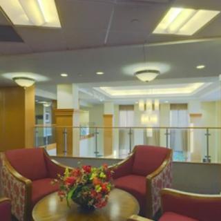 A cozy lobby area with seating and floral centerpiece.
