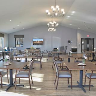 A modern dining area featuring stylish furniture and ample natural light.