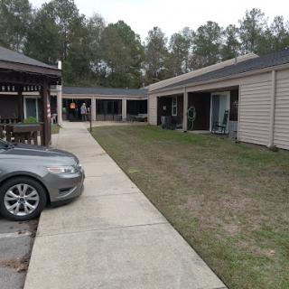 A view of a residential area featuring a driveway and parked car.