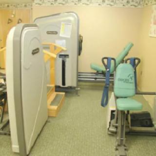 A fitness room with various exercise machines designed for workouts.