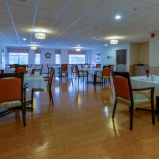 An empty dining room with neatly arranged tables and chairs.