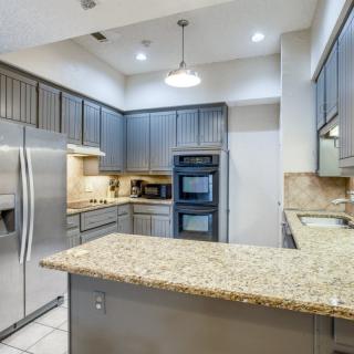 A modern kitchen with stainless steel appliances and granite countertops.