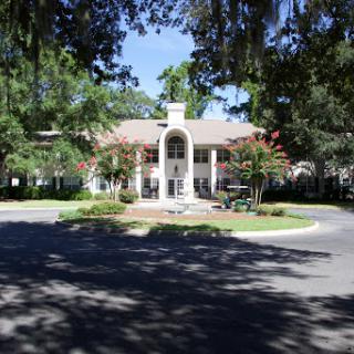 A beautiful architectural building surrounded by lush greenery and trees.