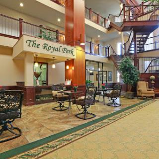 A spacious and elegantly designed hotel lobby featuring comfortable seating and a magnificent staircase.