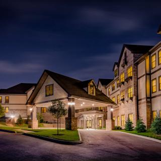 A well-lit hotel entrance at night.