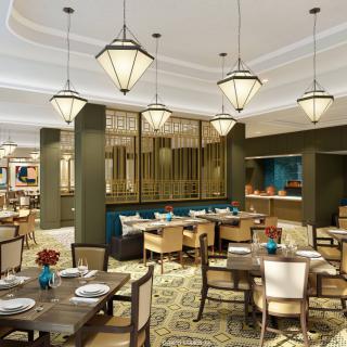 A modern restaurant with elegant chandeliers and stylish furnishings.