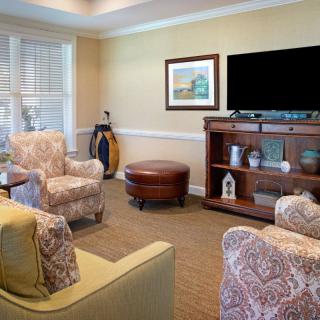 A cozy living room with comfortable seating, a television, and decorative elements.