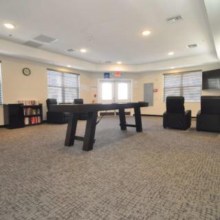 A spacious game room featuring a foosball table and comfortable seating.