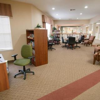 A well-furnished office space with desks, chairs, and bookshelves.