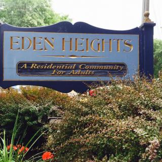 Sign for Eden Heights, a residential community for seniors, surrounded by greenery.