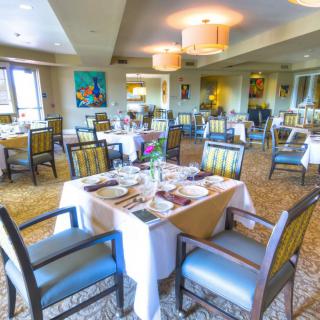 A well-arranged dining area in a restaurant with neatly set tables and chairs.