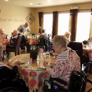 Residents enjoying a meal together in a communal dining area.