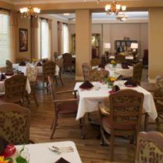 An elegant dining room setup with neatly arranged tables and chairs.
