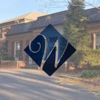 A serene view of a building featuring a stylized logo overlay.