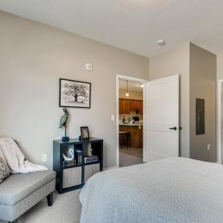 A modern, minimalist bedroom with sleek furnishings and neutral tones.