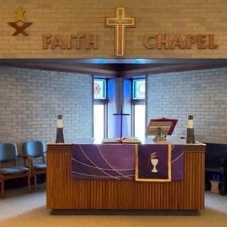 A tranquil chapel interior featuring an altar with religious decorations and a cross above it.