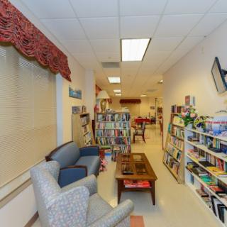 A cozy reading area featuring comfortable seating and bookshelves filled with various books.