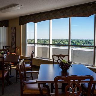 A dining area with large windows offering a scenic view.