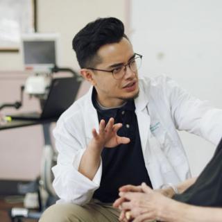 A doctor conversing with a patient during a consultation.