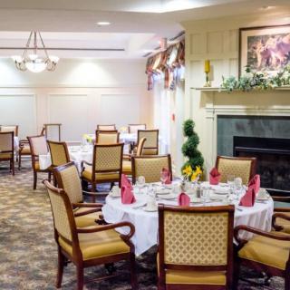 An elegant dining area with neatly arranged tables and chairs, featuring tasteful decor.