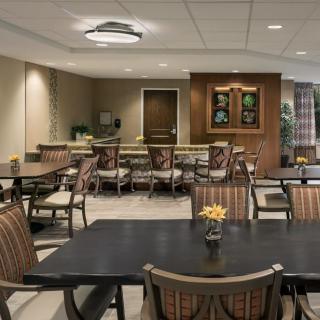 A modern dining area with neatly arranged tables and chairs.