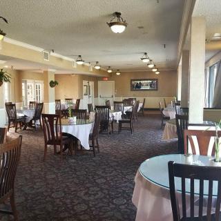 Spacious restaurant interior with neatly arranged tables and chairs.